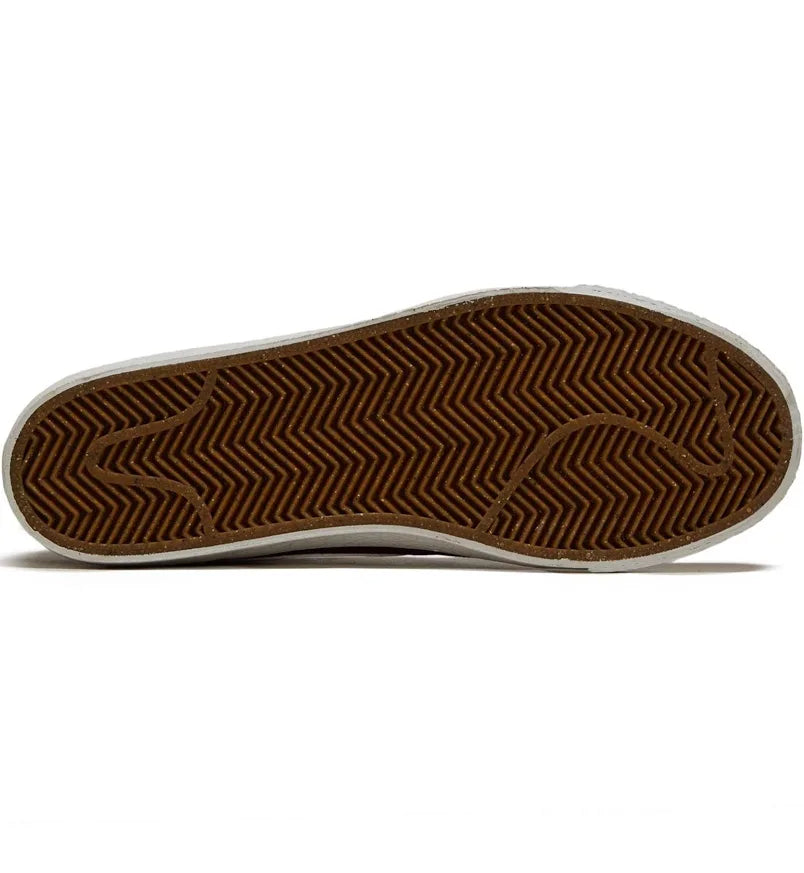 Burgundy mid-top sneaker outsole with textured herringbone tread