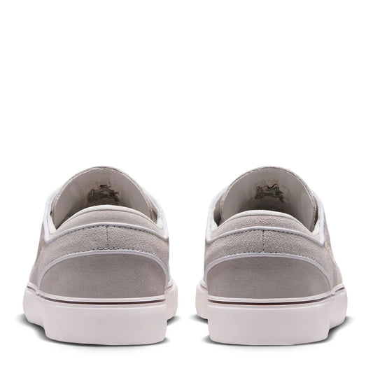 Back view of light gray suede low-top skate shoes with white rubber heel