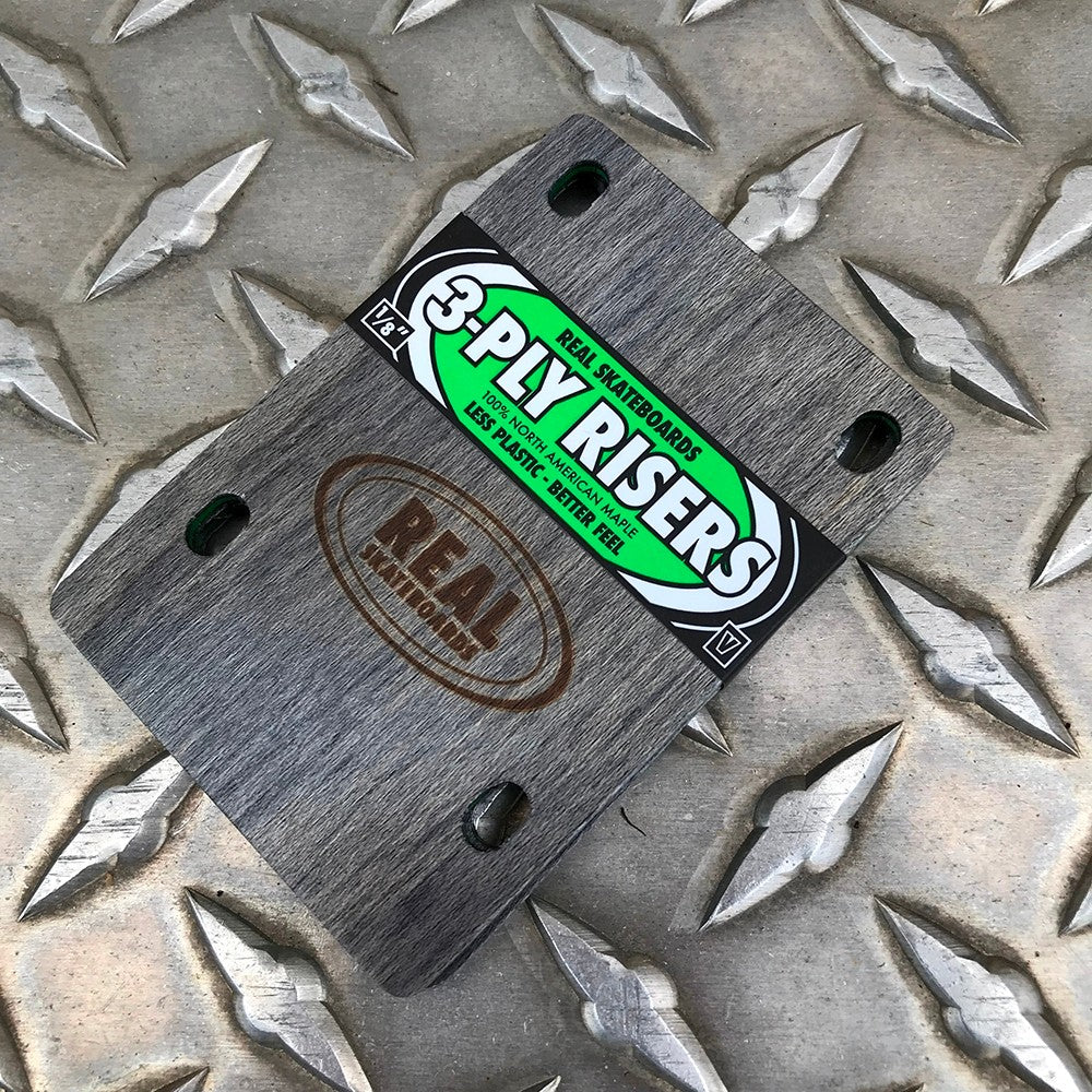 3-ply riser pad, dark gray with four mounting holes and green logo