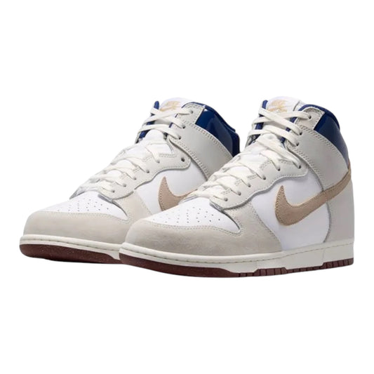 Front three-quarter view of white and blue high-top sneakers with tan swoosh details