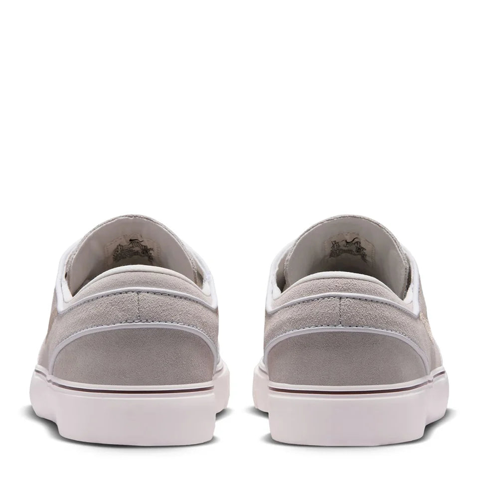 Back view of light gray suede low-top skate shoes with white rubber heel