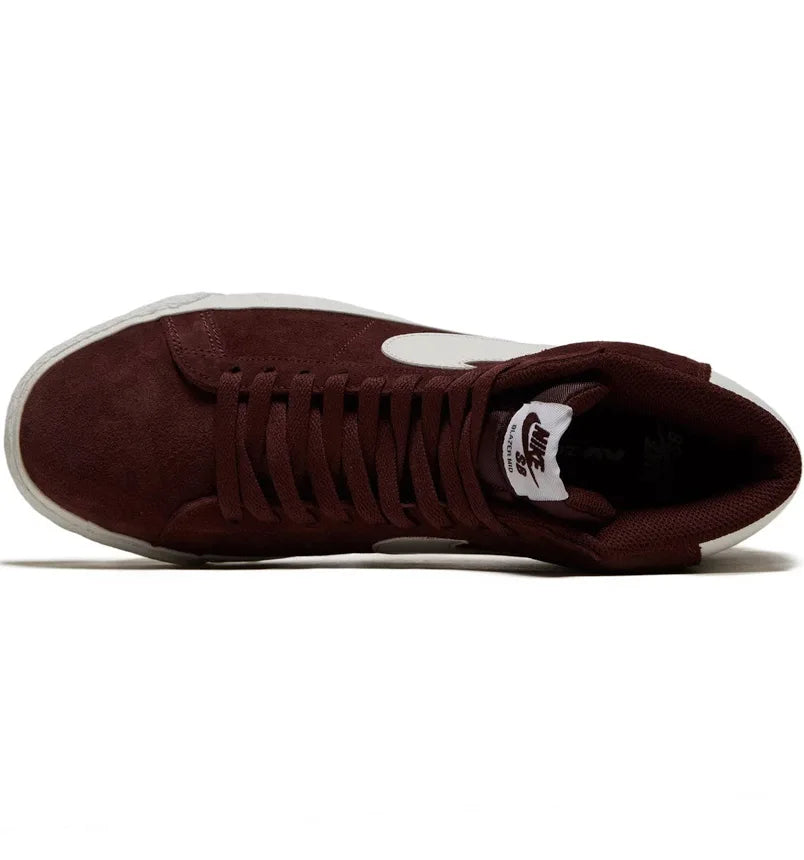 Burgundy mid-top sneaker with white swoosh and lace-up opening