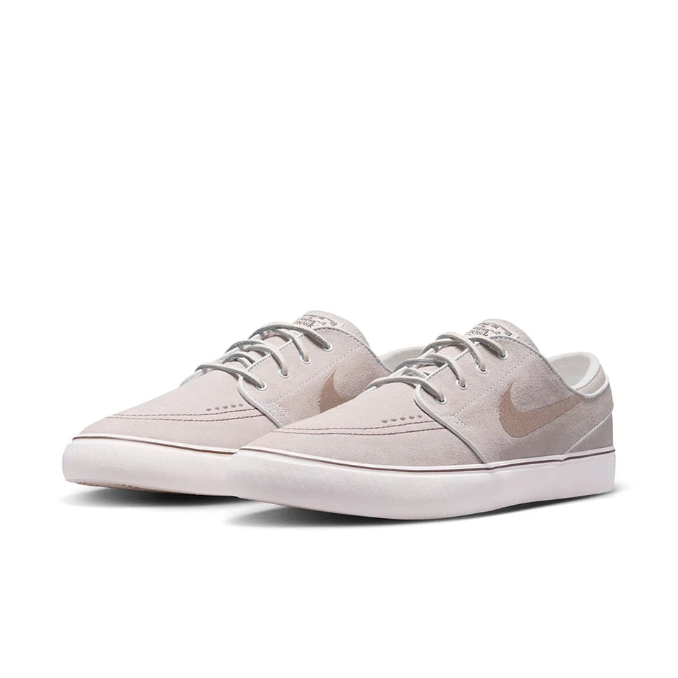 Light gray low-top skate shoes with swoosh logo, lace-up design and white midsole