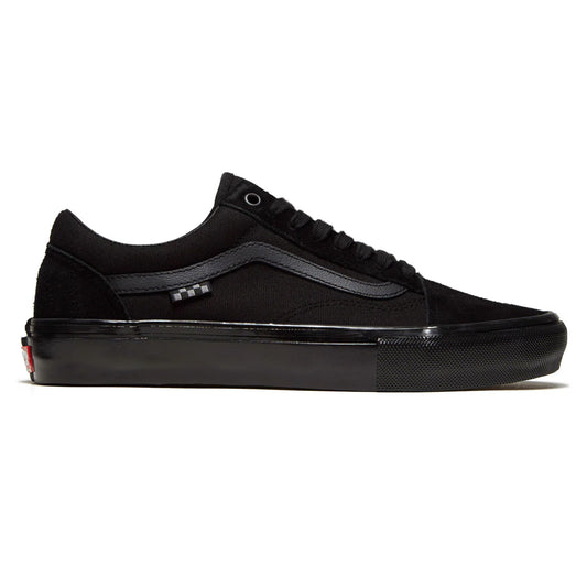 Black low-top skate sneakers with padded tongue, lace-up front and side stripe